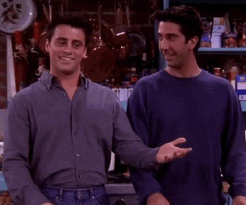 The characters of Joey and Ross from the sitcom friends gesture to the camera and say 'happy thanksgiving, everybody'