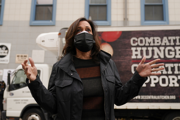 Vice President-elect Kamala Harris answers a question from the media while wearing a mask.
