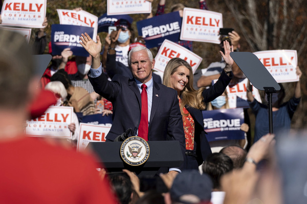Vice President Mike Pence and Kelly Loeffler wave to the crowd during a Defend the Majority Rally in Canton