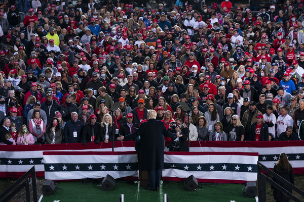 Donald Trump stages in front of a large crowd at a rally.