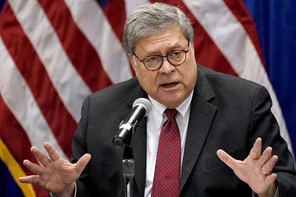 US Attorney General William Barr gestures while speaking at a microphone