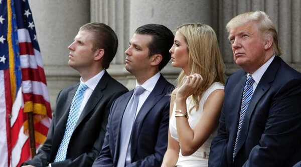 Donald Trump sits with his children Eric, Don Jr and Ivanka