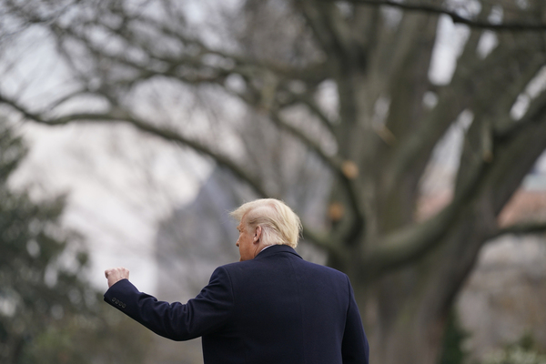 President Donald Trump gestures to supporters as he walks on the South Lawn of the White House in Washington
