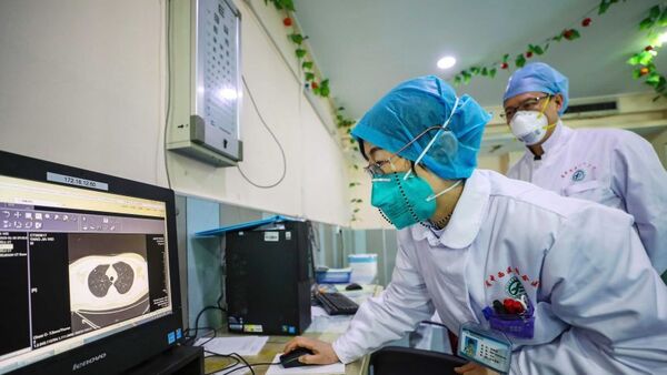 Doctors look at a CT scan of a patient at a hospital in Wuhan in central China's Hubei Province.