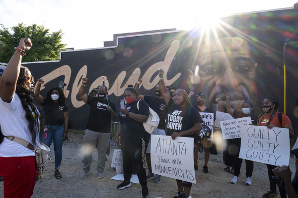 People gather before a march in Atlanta, Tuesday, April 20, 2021, after former Minneapolis police Officer Derek Chauvin was found guilty on all counts