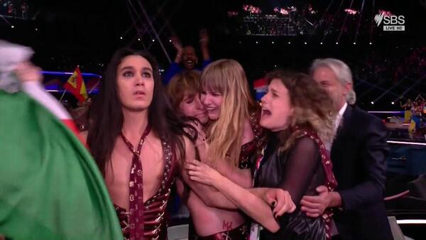Performers from Italy's Eurovision act hug each other as they process the voting results. 