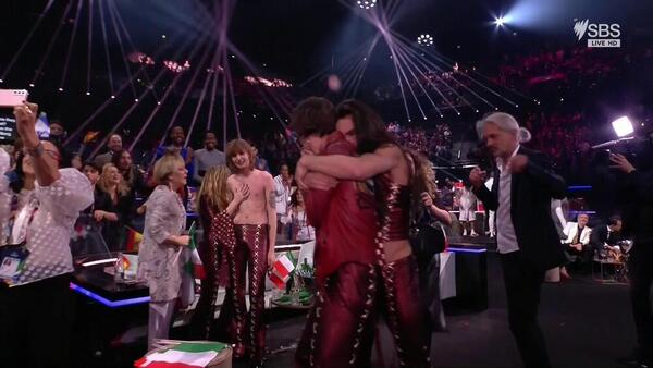 Performers from Italy's Eurovision act hug each other as they process the voting results. 