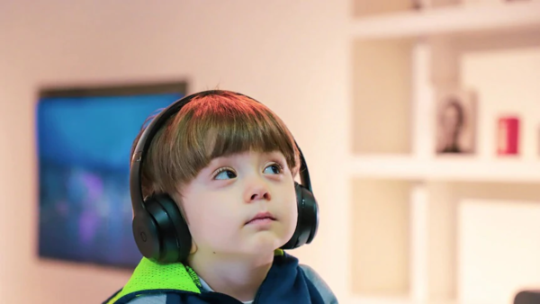 A child sits with headphones on