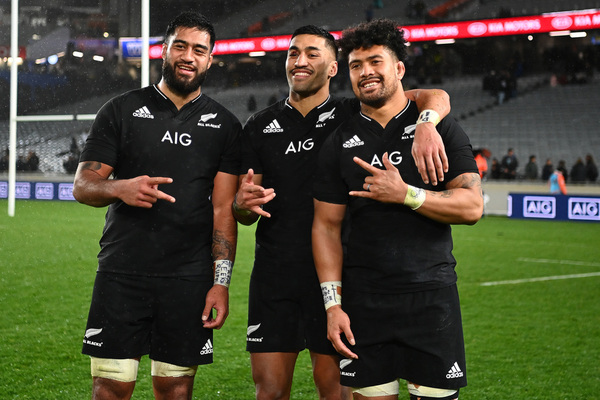 Three All Blacks players celebrate beating the Wallabies.