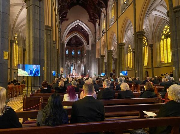 Crowds of mourners sit on pews inside St Patrick's Cathedral.