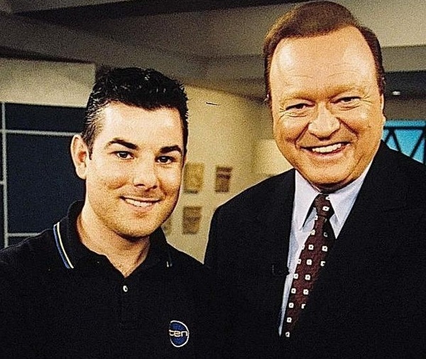 Robert Mascara and Bert Newton stand together smiling on the set of GMA.