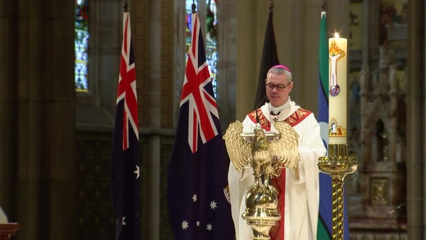 Archbishop Peter Comensoli speaks at the lectern in the cathedral.