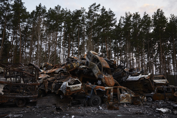 an enormous pile of burned shells of cars