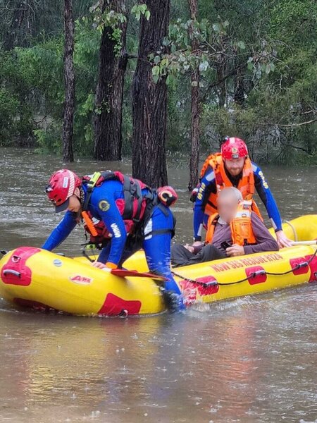 A man in a life raft with his resuers